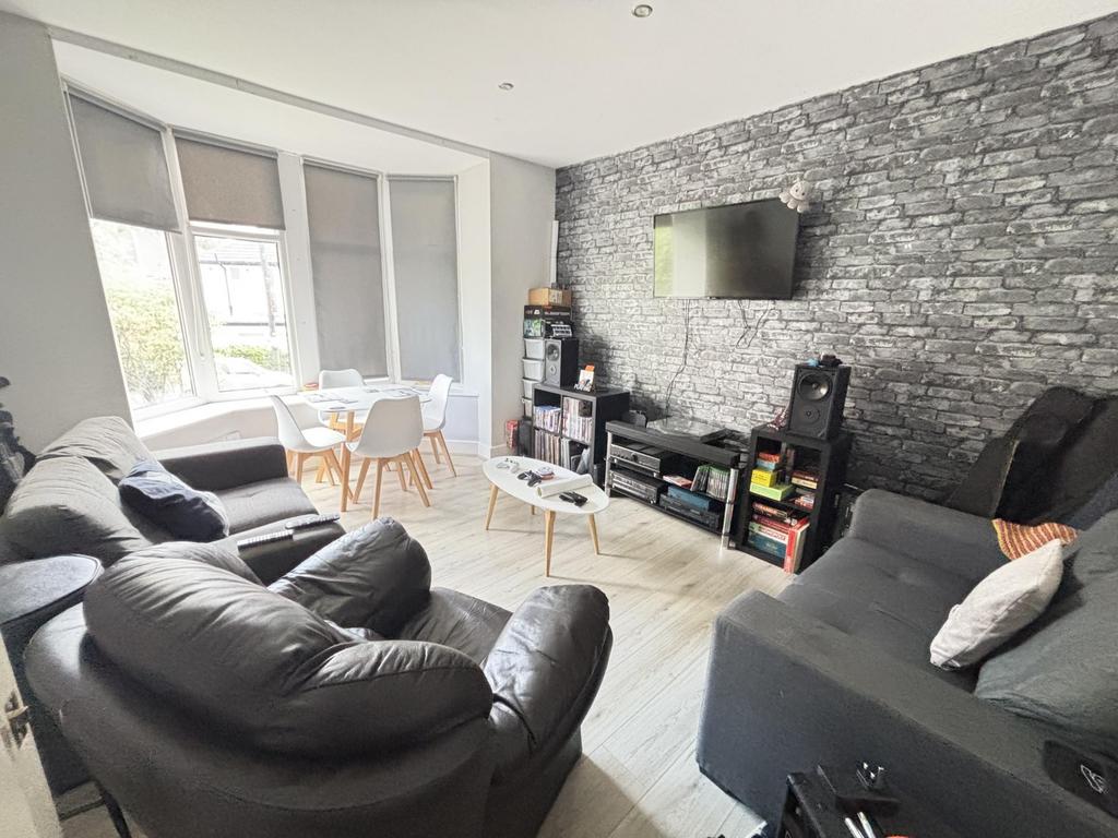 Spacious and modern living room featuring comfo...