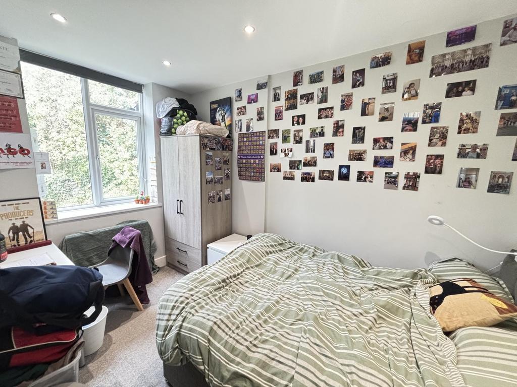 A cozy single bedroom featuring a bed and perso...