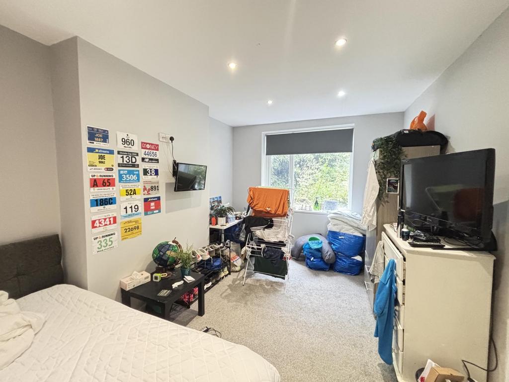 A cozy bedroom with a bed, various personal bel...