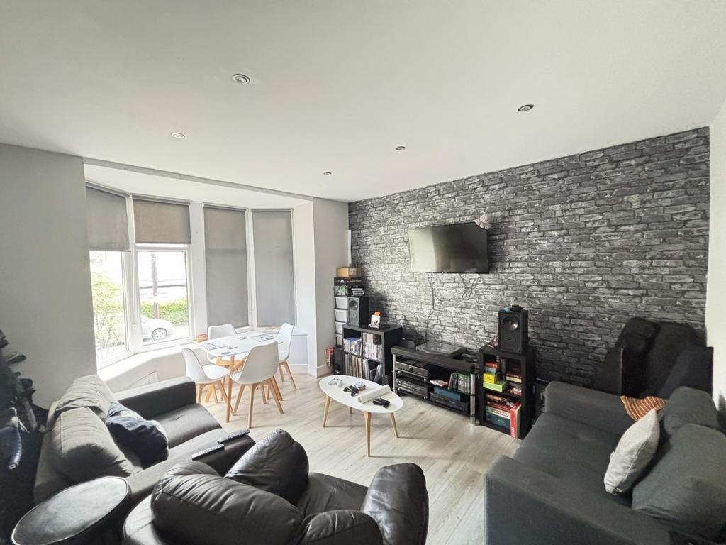 A bright, spacious living room featuring modern...