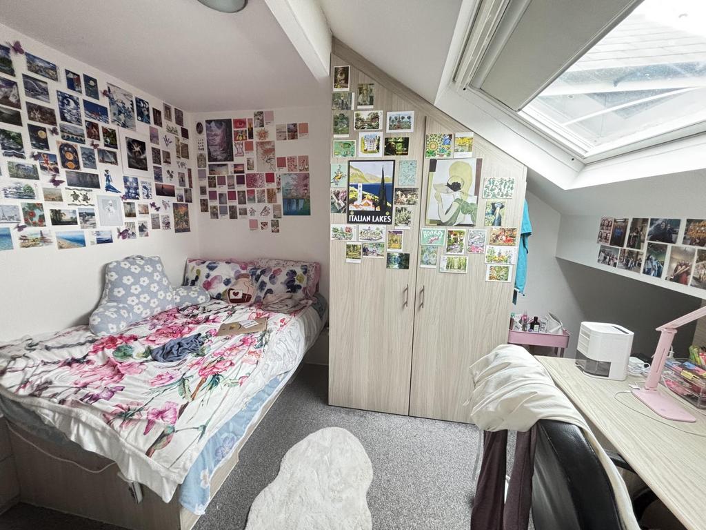 A bright and inviting bedroom with a large wind...
