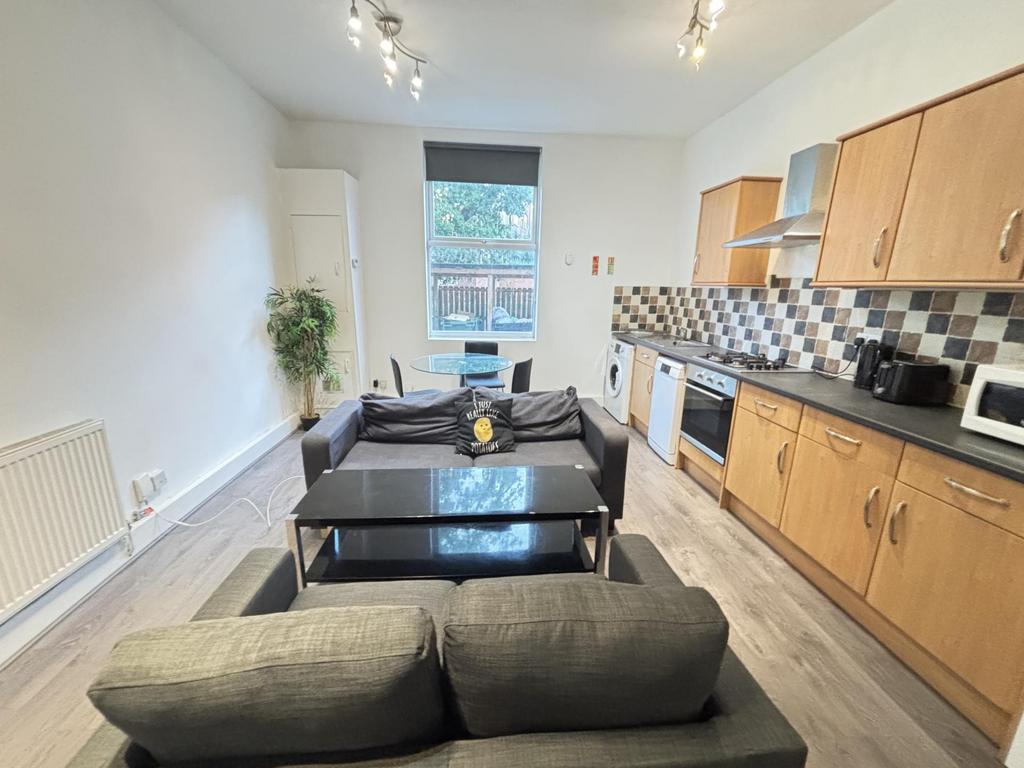 A spacious and well-lit living room with modern...