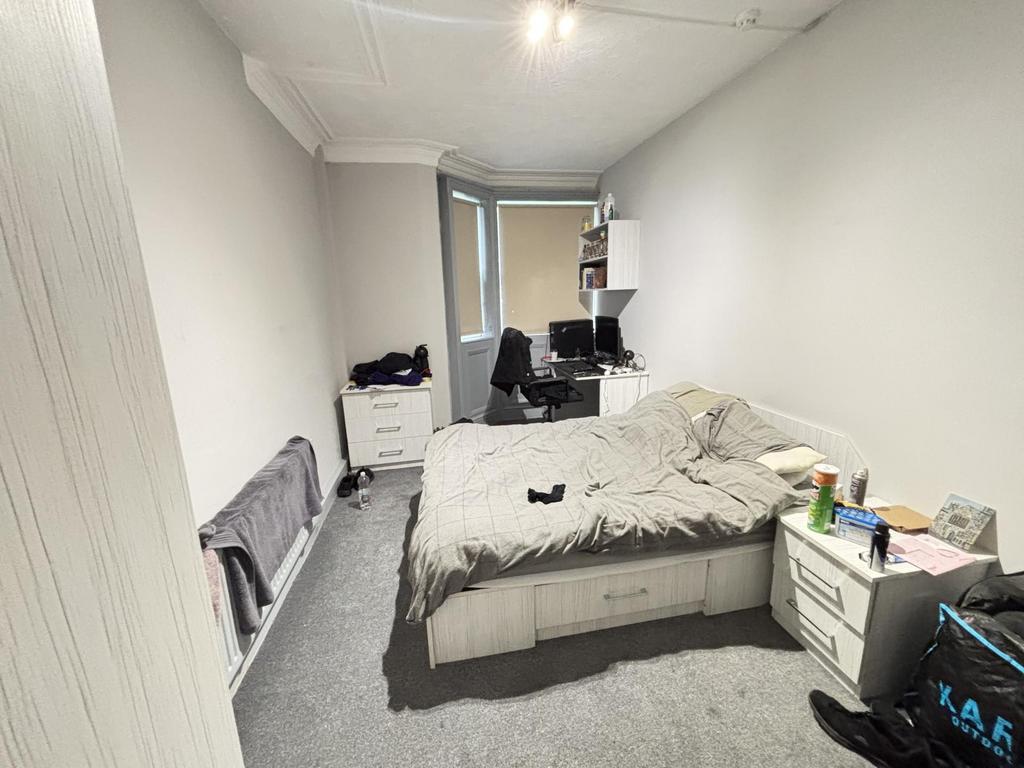 A spacious master bedroom featuring a double be...