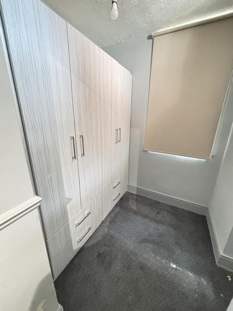 A cozy, well-maintained bedroom with a large wa...