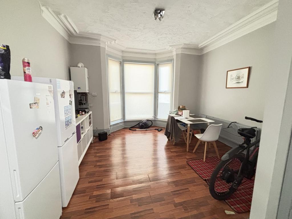 A bright and airy living room with large window...