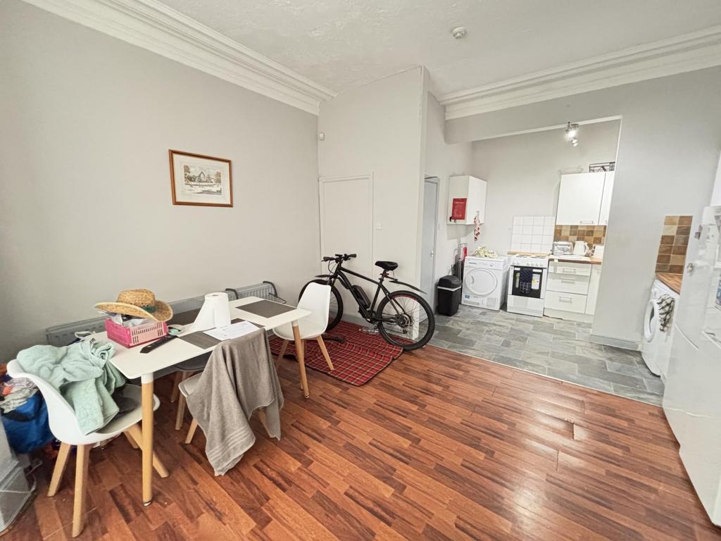 Bright and spacious living room with wooden flo...