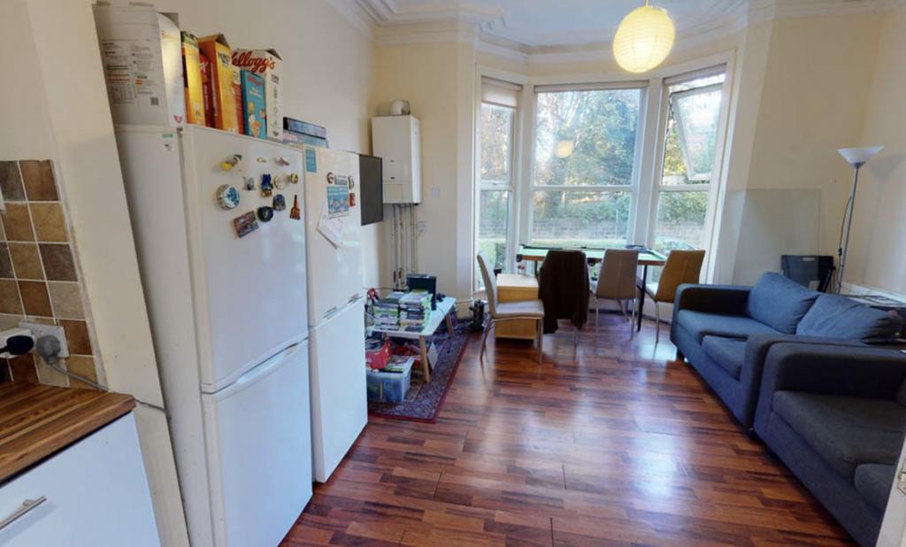 A bright and welcoming living room featuring la...