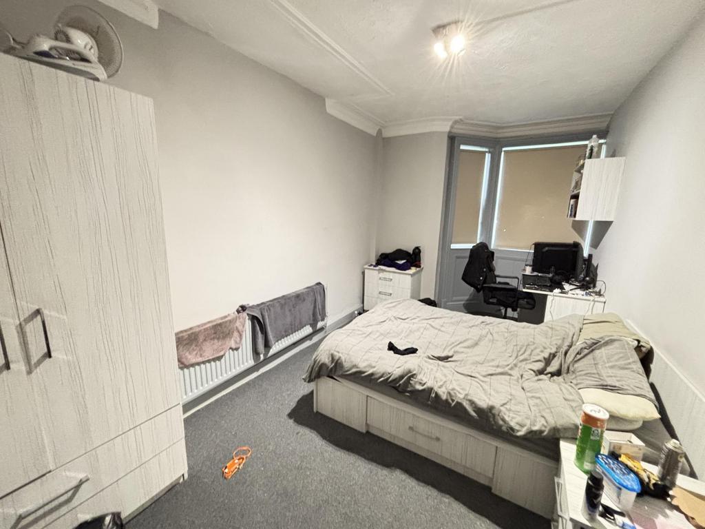 A cozy bedroom with a double bed, minimal clutt...
