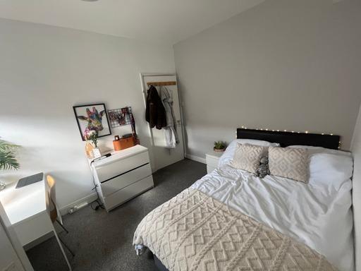 A well-maintained bedroom featuring a double be...
