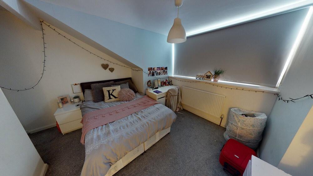 A cozy bedroom with a single bed, decorated wit...
