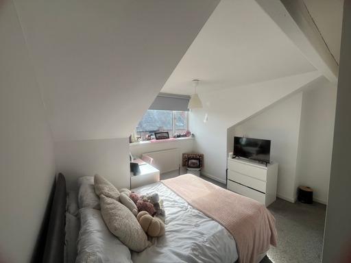 A bright and spacious master bedroom featuring ...