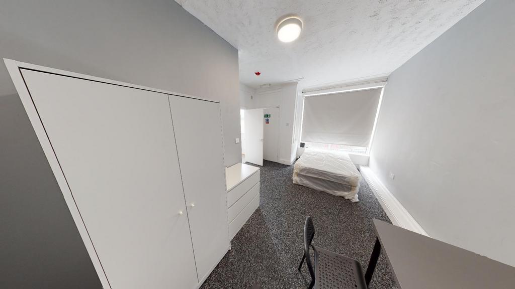 A bright, well-maintained bedroom with a clean ...