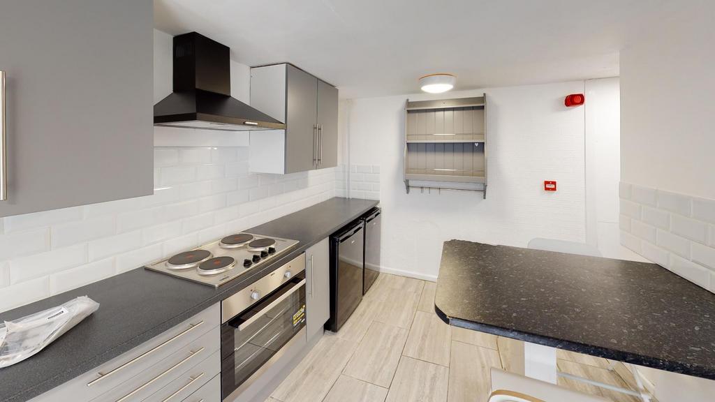 Modern fitted kitchen with integrated oven and ...
