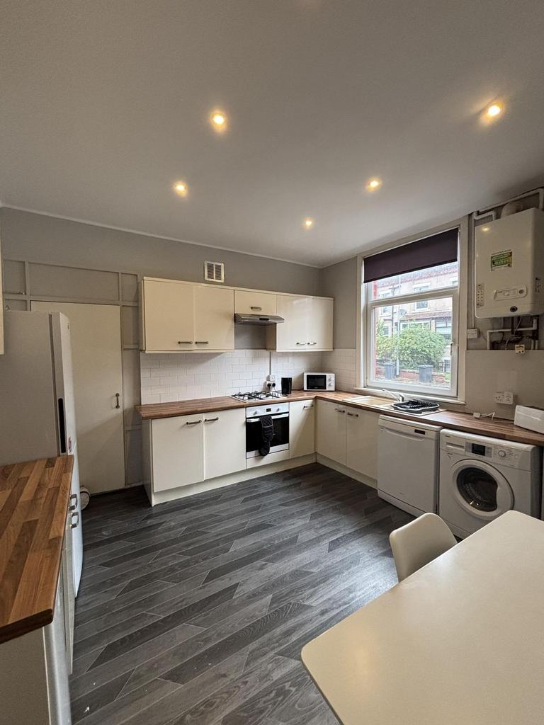 Bright and modern kitchen with ample cabinet sp...