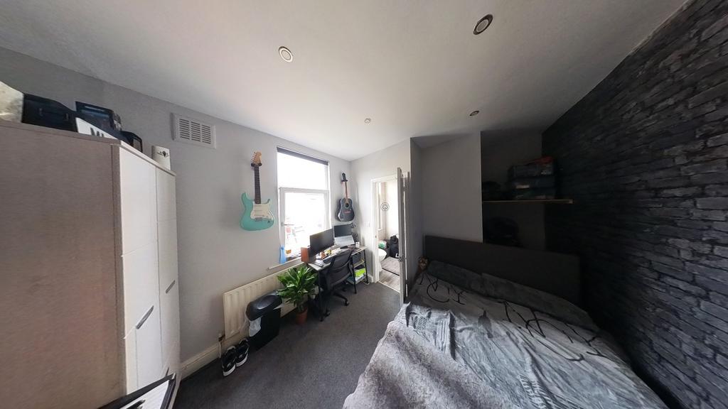 A bright and well-maintained bedroom filled wit...