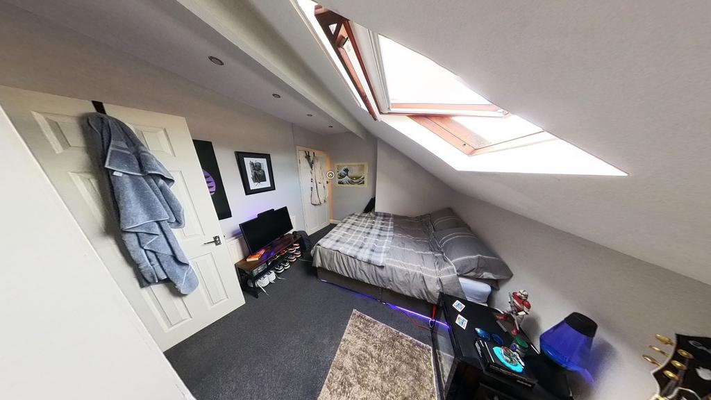 A cozy, well-maintained bedroom with natural li...