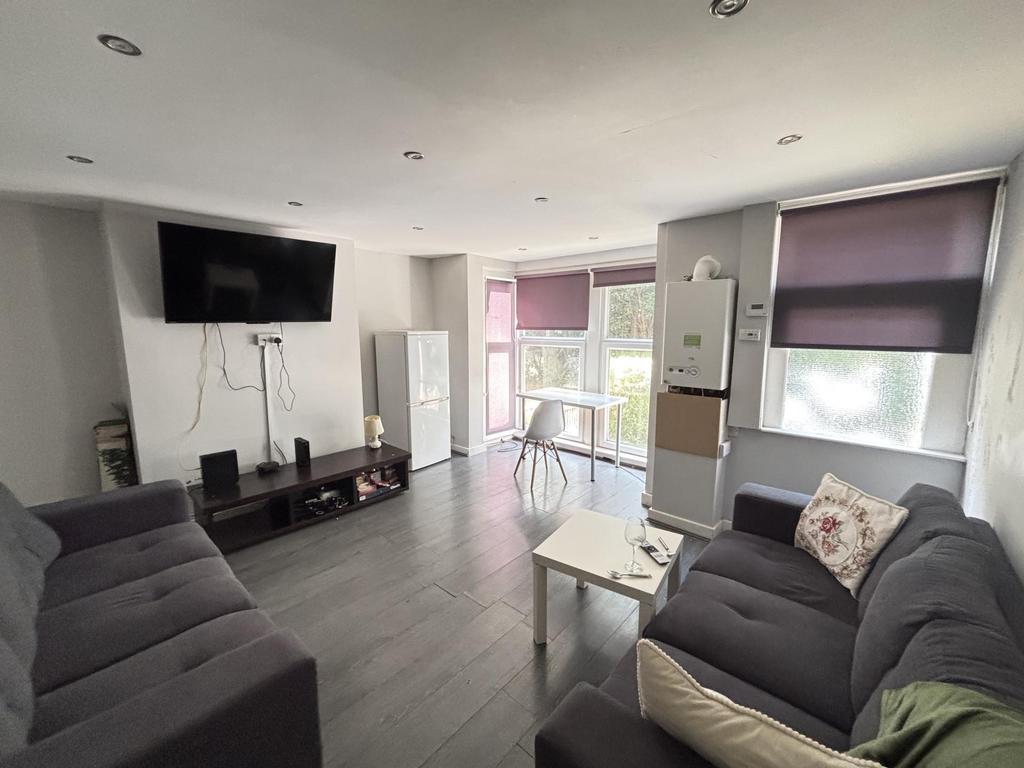 Bright and spacious living room featuring comfo...