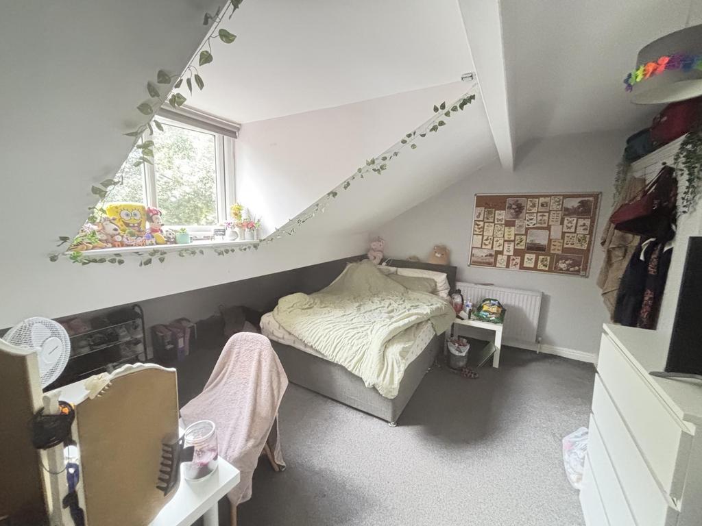 A bright and well-maintained bedroom featuring ...