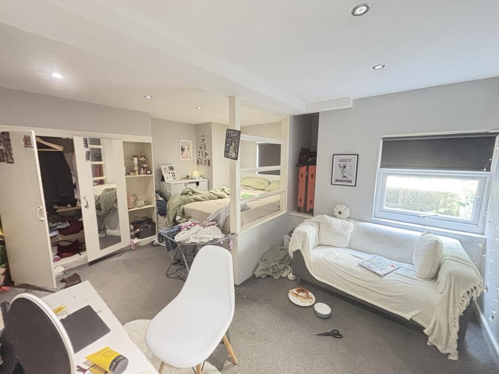 A bright and inviting living room featuring com...