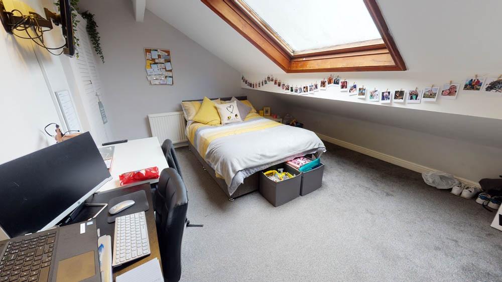 A well-lit, spacious double bedroom with ample ...