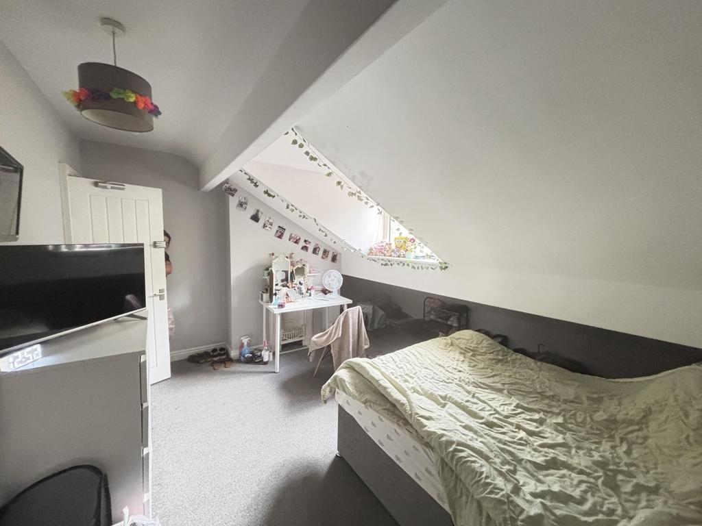 A well-maintained bedroom with a comfortable be...