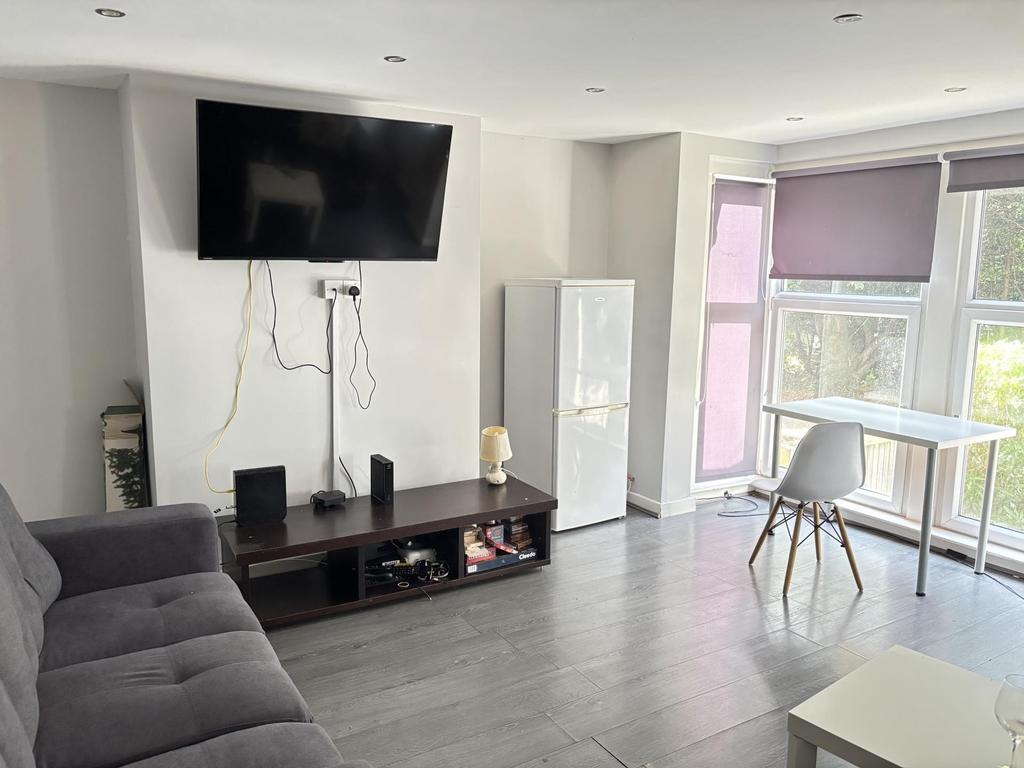A bright and modern living room featuring a lar...