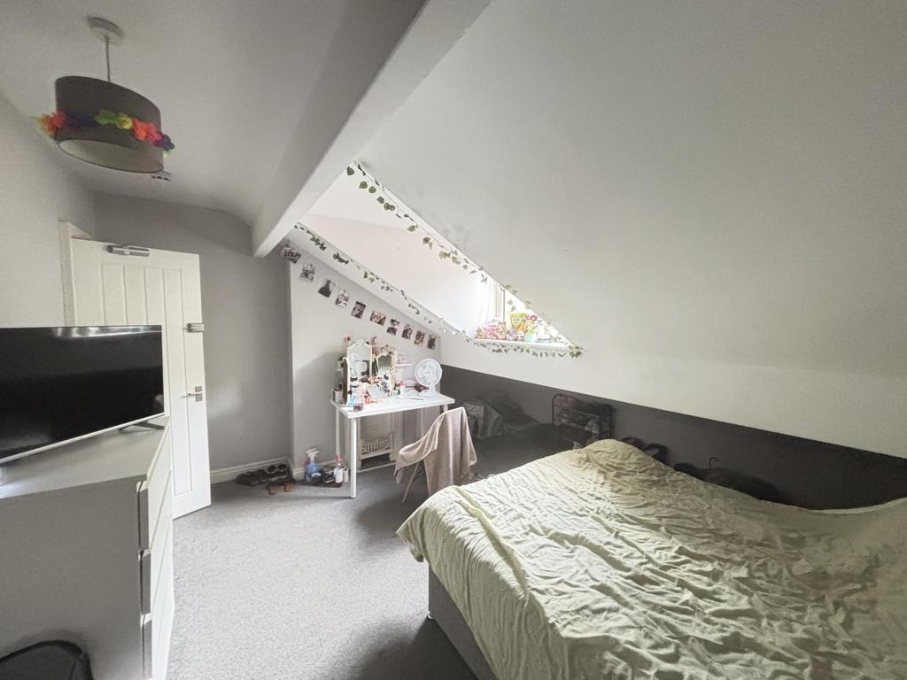 A well-maintained bedroom featuring a double be...