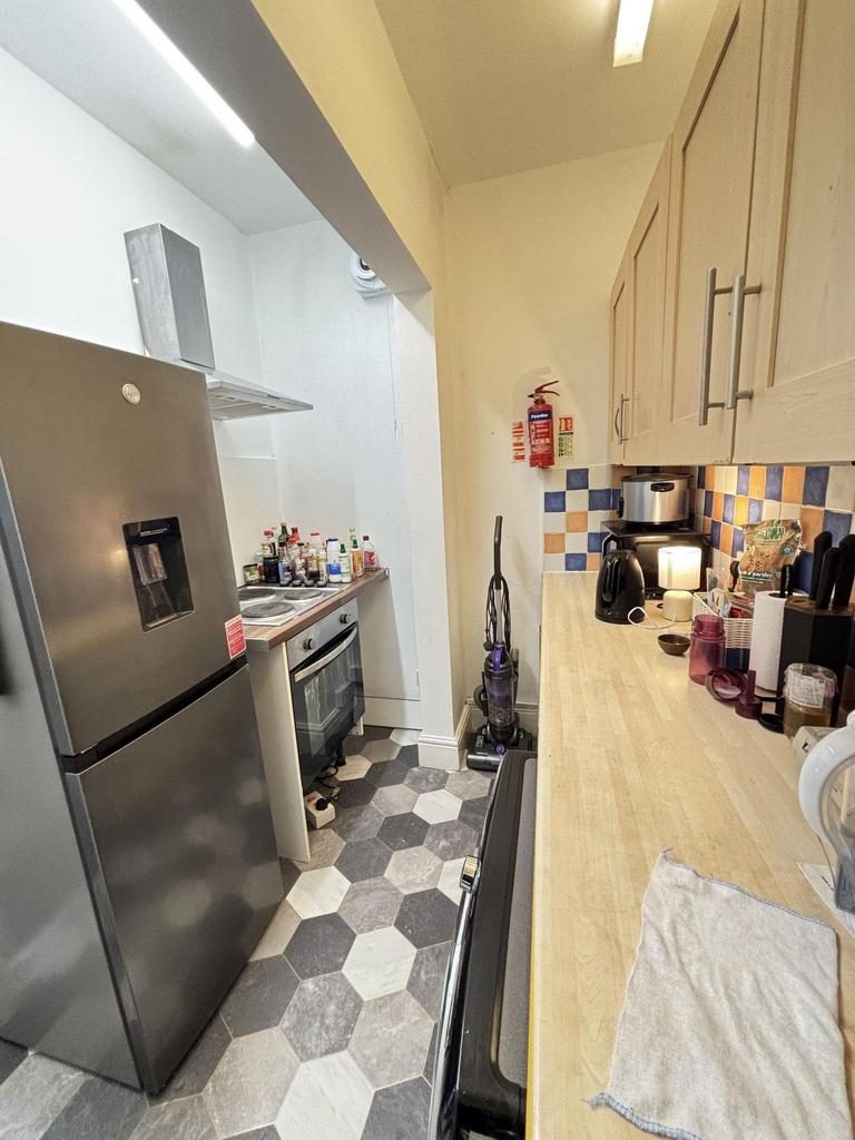 A compact kitchen with modern appliances and a ...