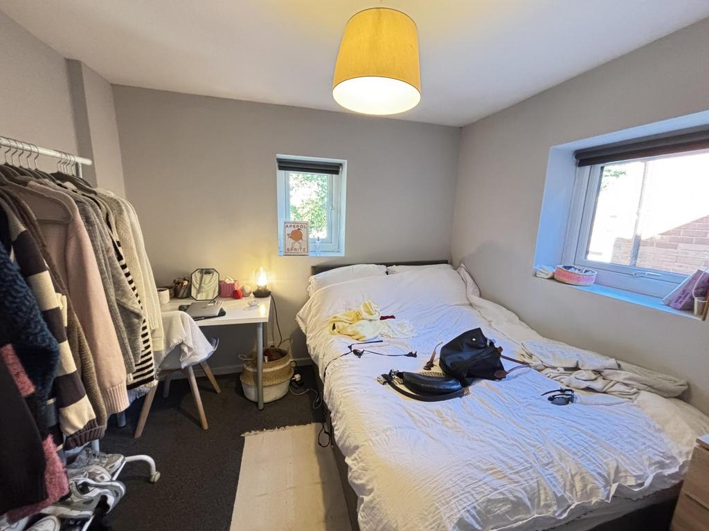 A cozy bedroom with a comfortable double bed, w...