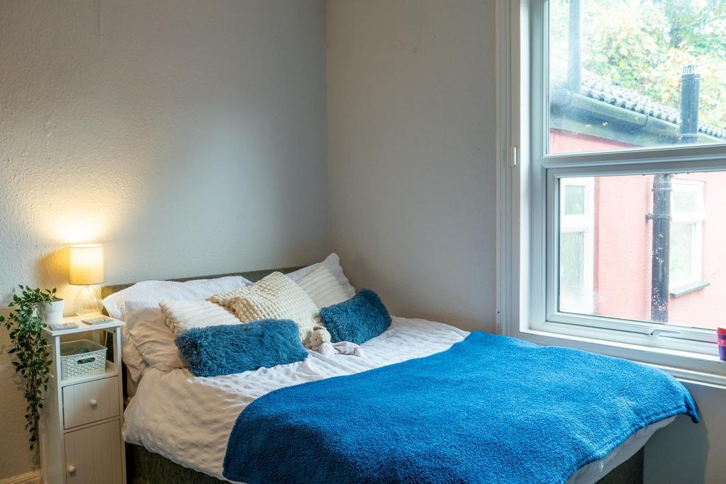 A bright and inviting double bedroom featuring ...