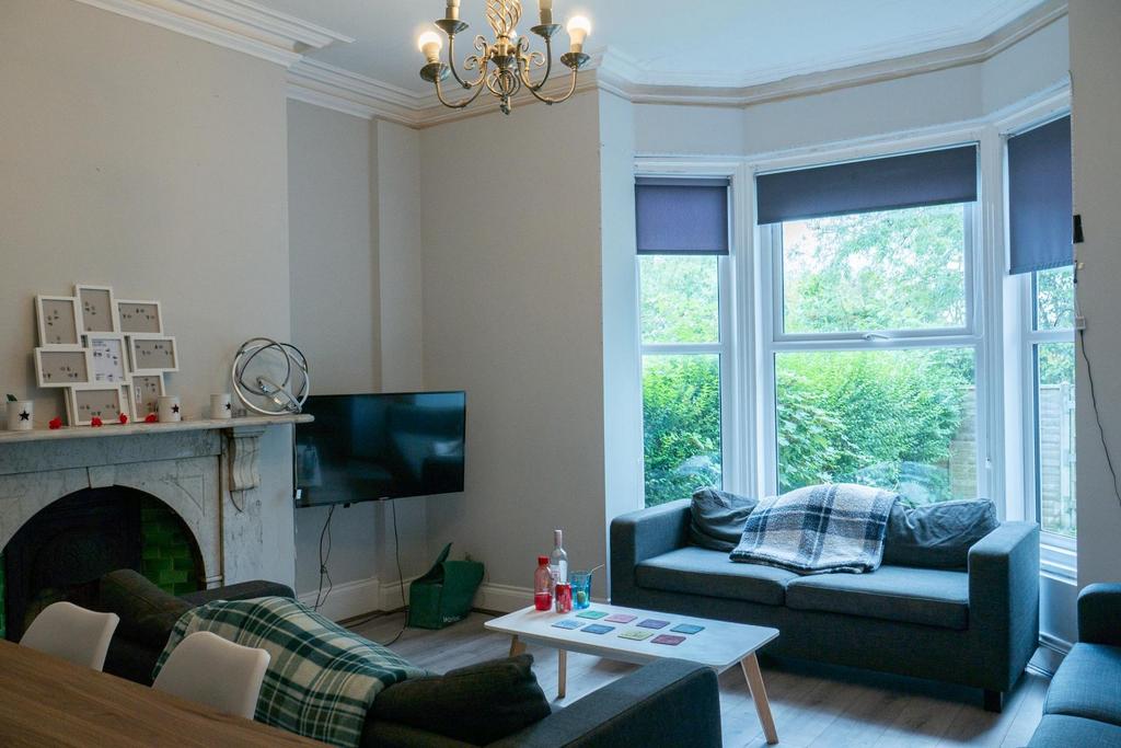 Bright and spacious living room featuring large...