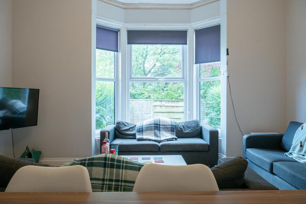 A well-lit and inviting living room featuring a...