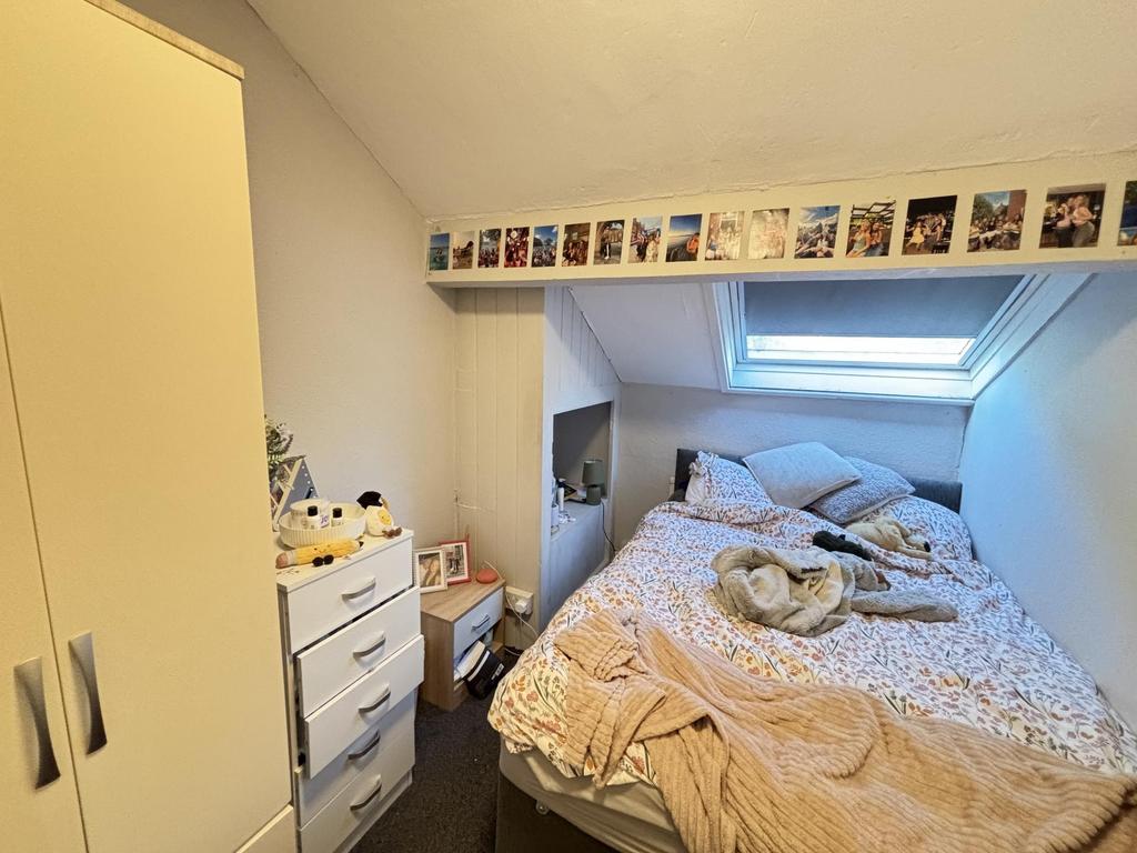 A spacious and well-lit bedroom featuring a lar...