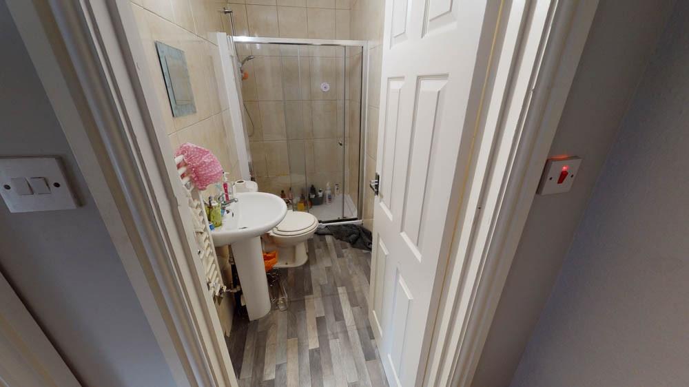 A clean and modern bathroom with a shower and b...