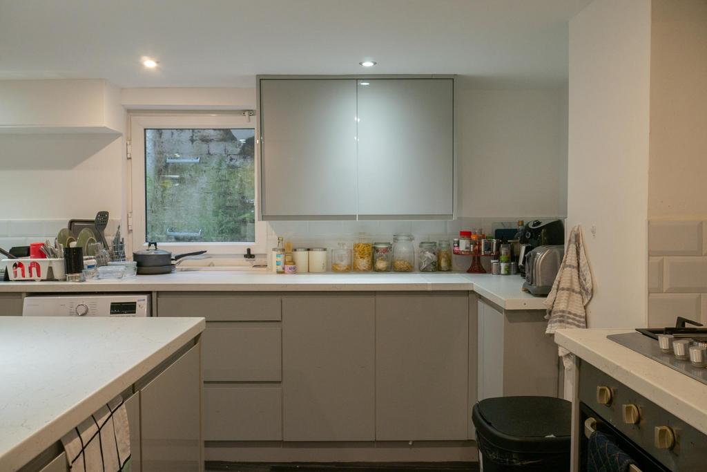 A modern, well-lit kitchen featuring ample coun...