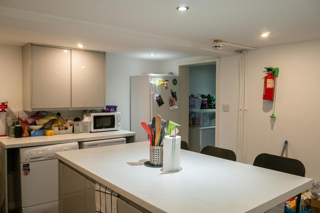 A bright and modern kitchen featuring a spaciou...