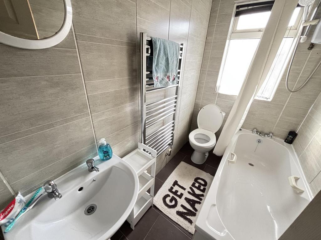 A modern, bright bathroom with a spacious bath ...