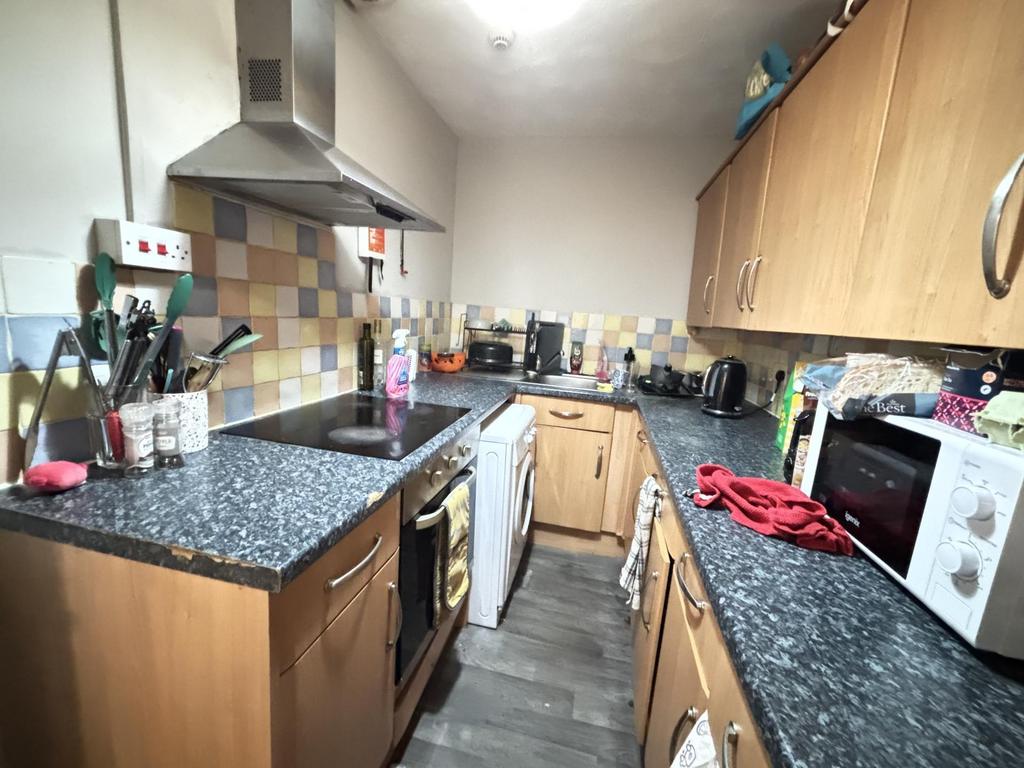 A well-equipped kitchen featuring wooden cabine...