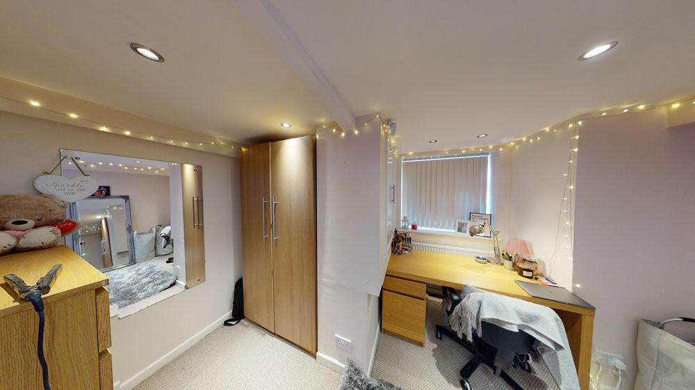 A cozy student bedroom featuring a double bed w...