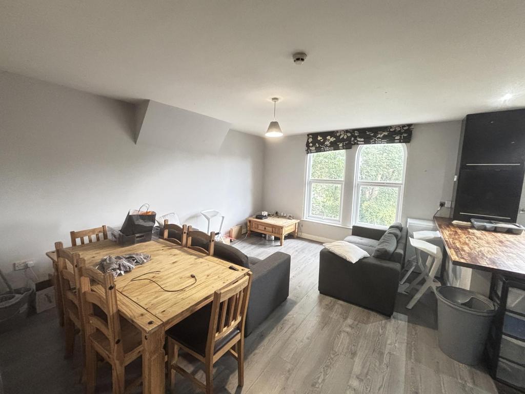 A bright and welcoming living room featuring a ...