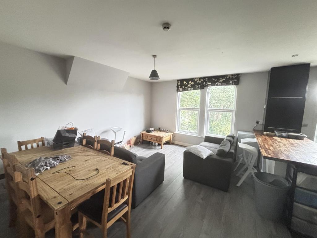 Bright and welcoming living room with ample nat...