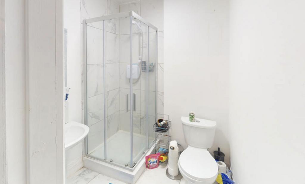 A clean and functional bathroom featuring a sho...