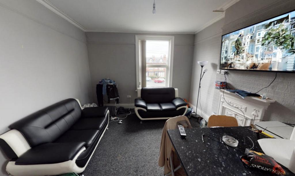 A modern, well-lit living room with comfortable...