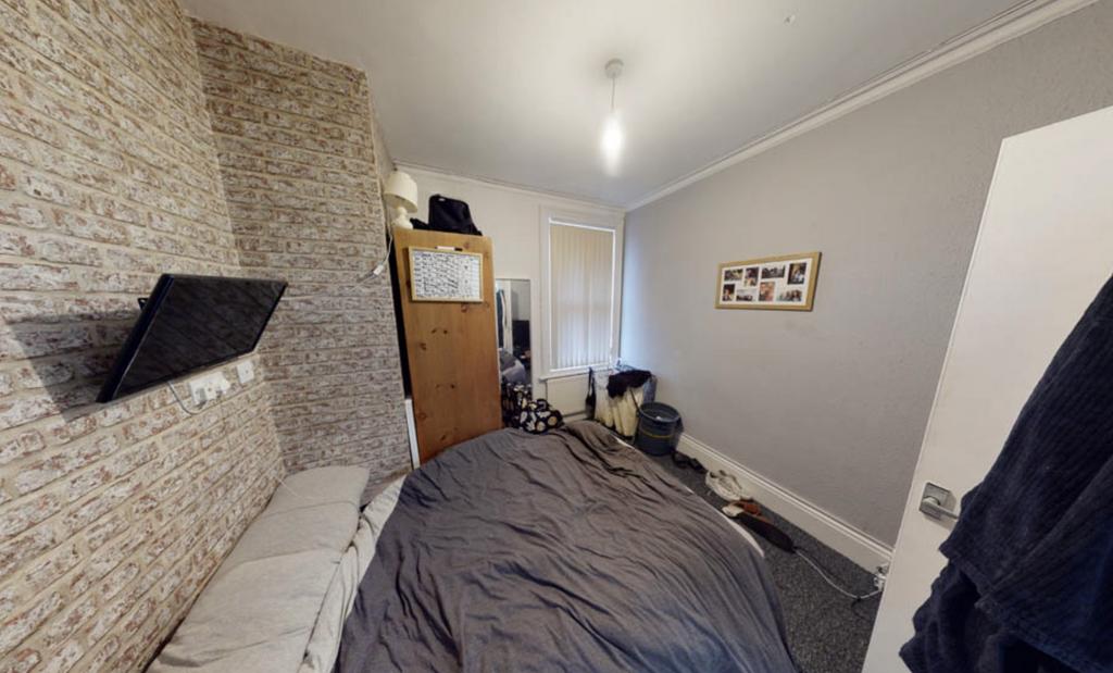 A cozy bedroom with a large bed, featuring a wi...
