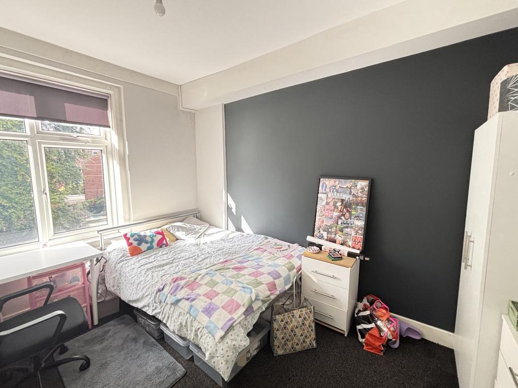 A bright and welcoming bedroom featuring a doub...