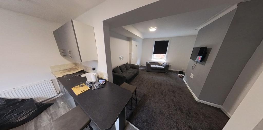 A spacious and well-lit living room with contem...