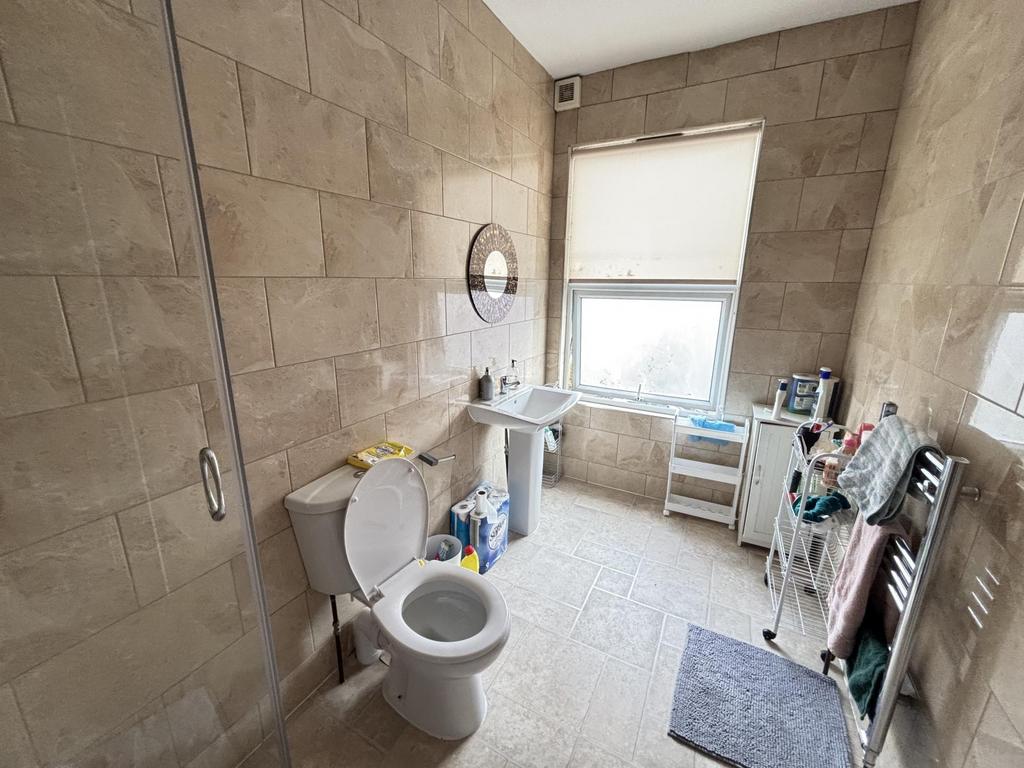 A spacious bathroom featuring a large white toi...