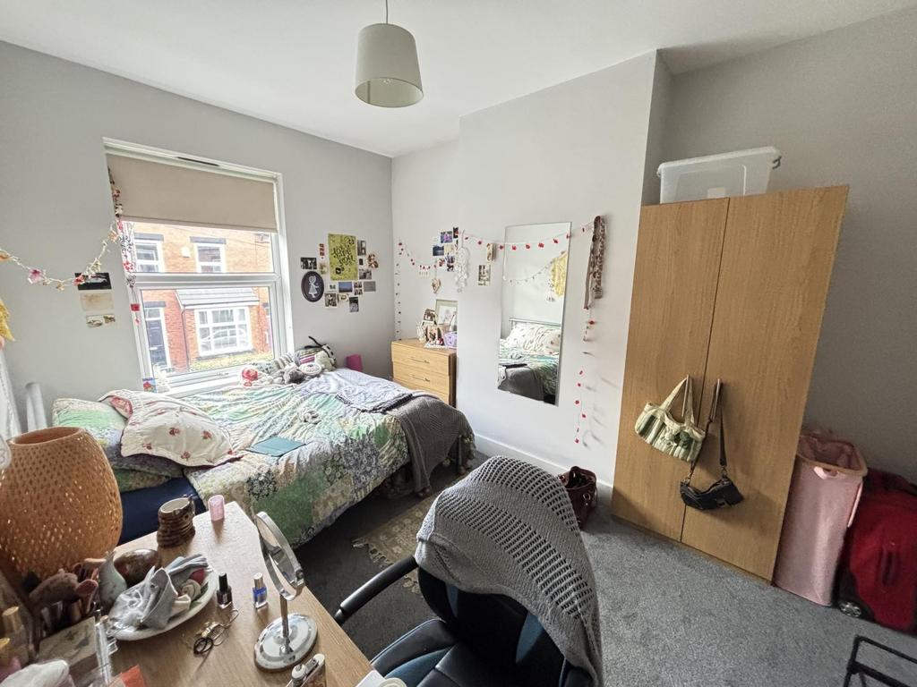 A cozy bedroom with a double bed and various pe...