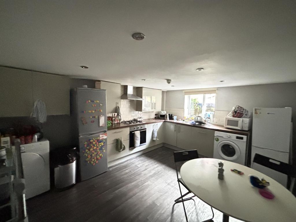 A modern and well-lit kitchen featuring applian...