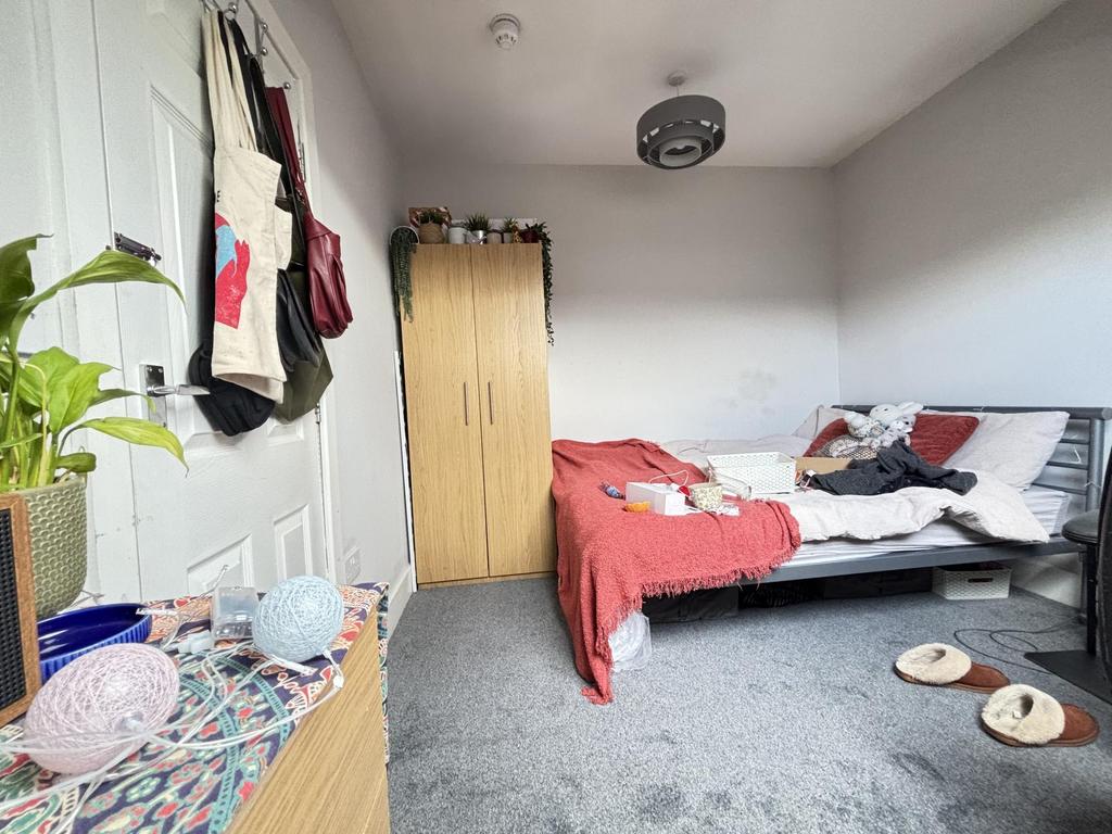 A cozy bedroom featuring a double bed with bedd...